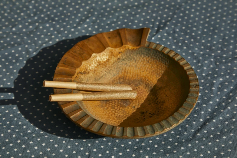 three wooden bowls sitting on top of a blue table