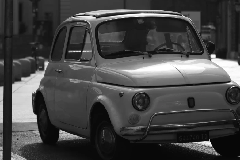 an old, white car parked in the city