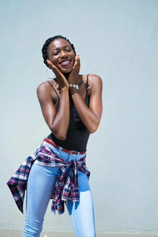 a woman wearing blue jeans posing for the camera