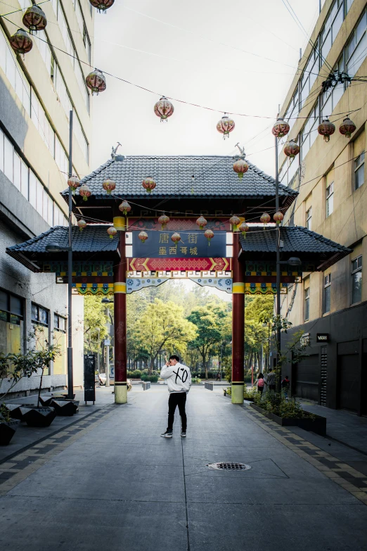 a man that is standing in the middle of a walkway