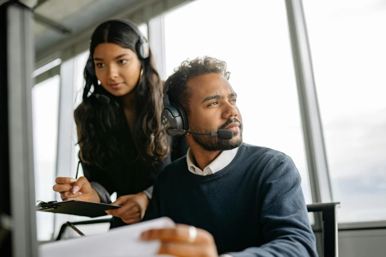 a woman in headphones with a man with a microphone