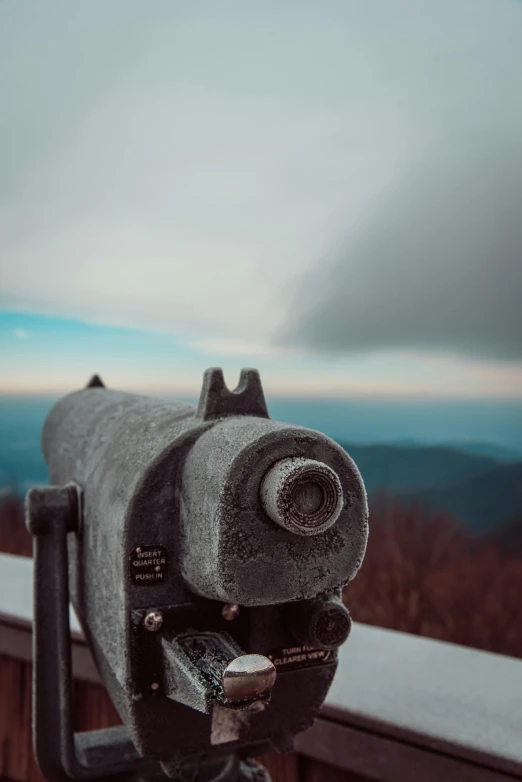 an old grey telescope with the view in the background
