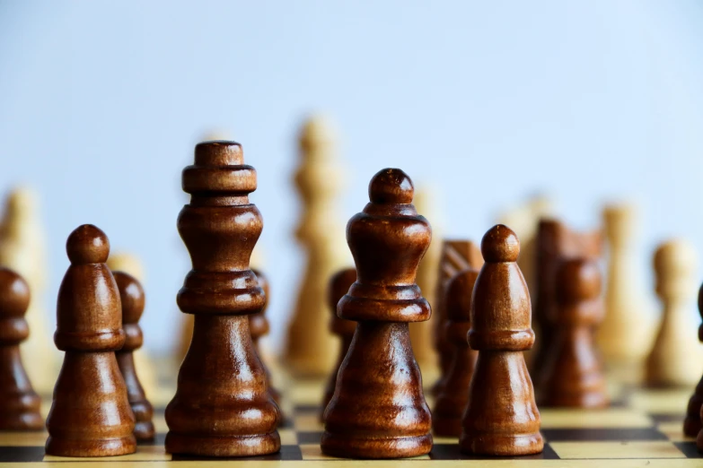 a group of brown and white chess pieces