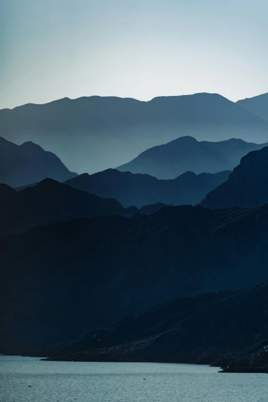 a body of water sitting in front of a mountain