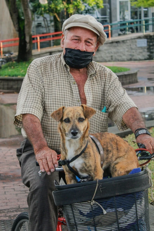 the elderly man is riding his bike with his dog