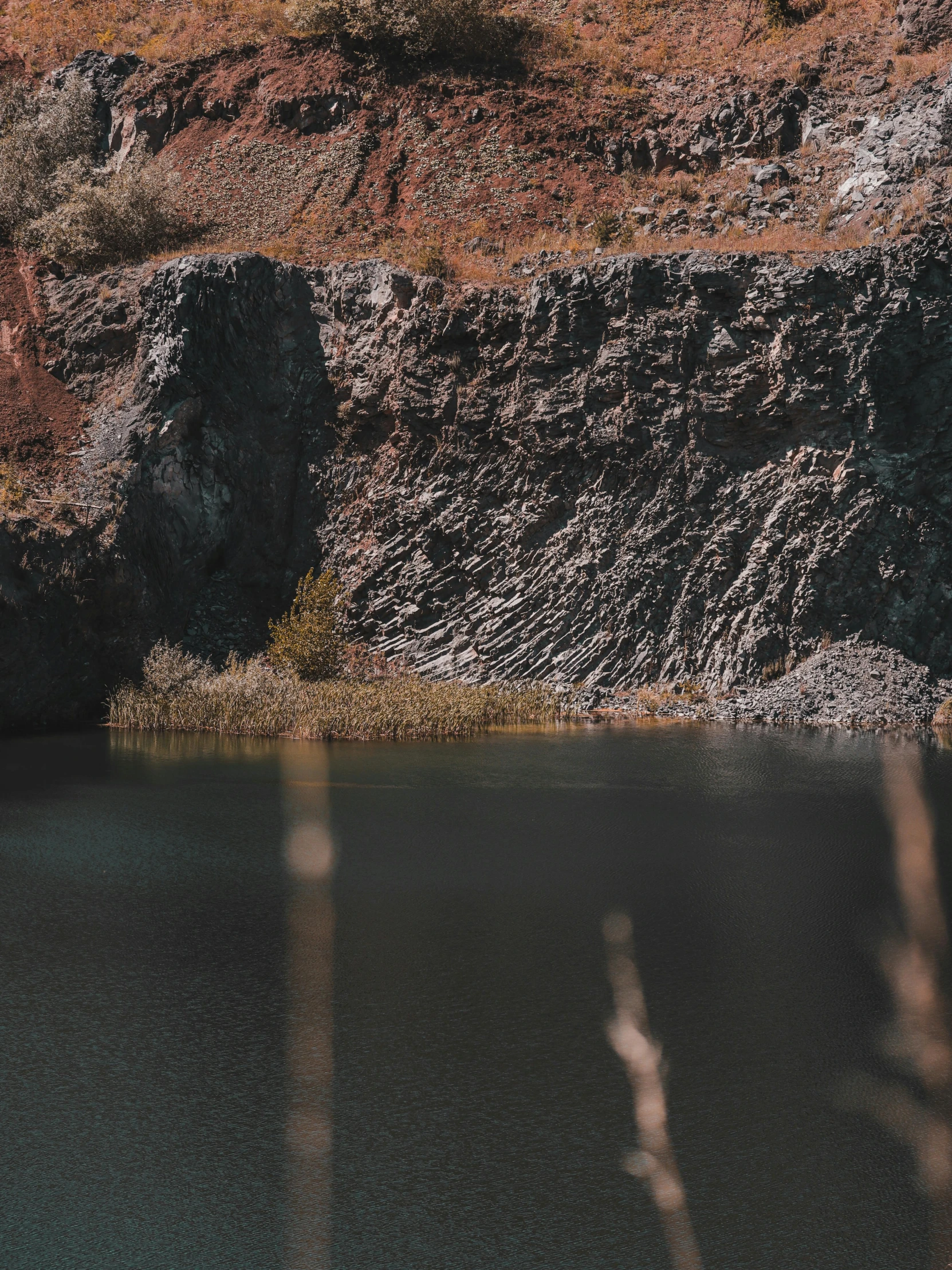 there are rocks, water, and a few vegetation on this land