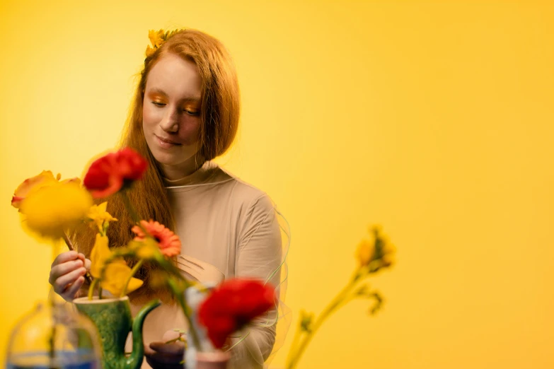 a woman looking at the center of a vase full of flowers