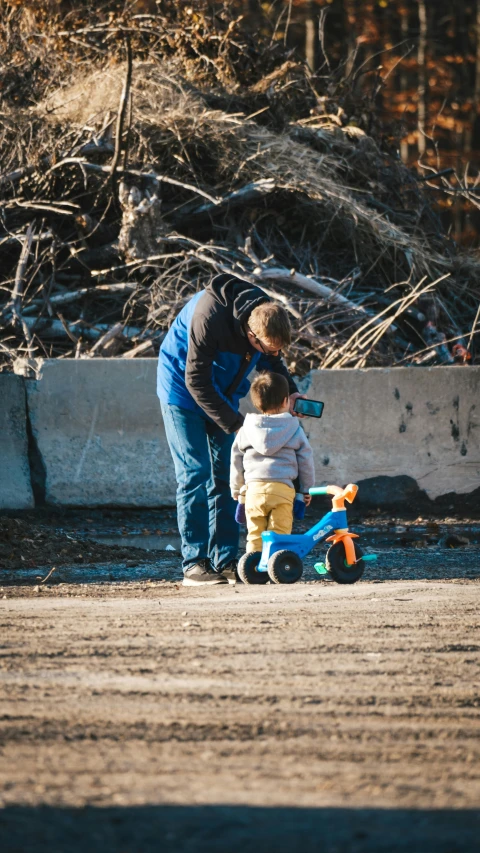 a man standing next to a small child