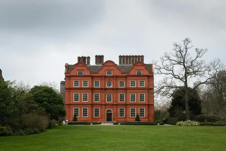 a large red building in a green field