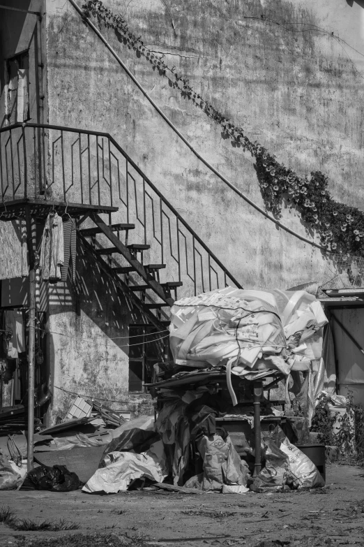 an abandoned building with garbage scattered on the ground