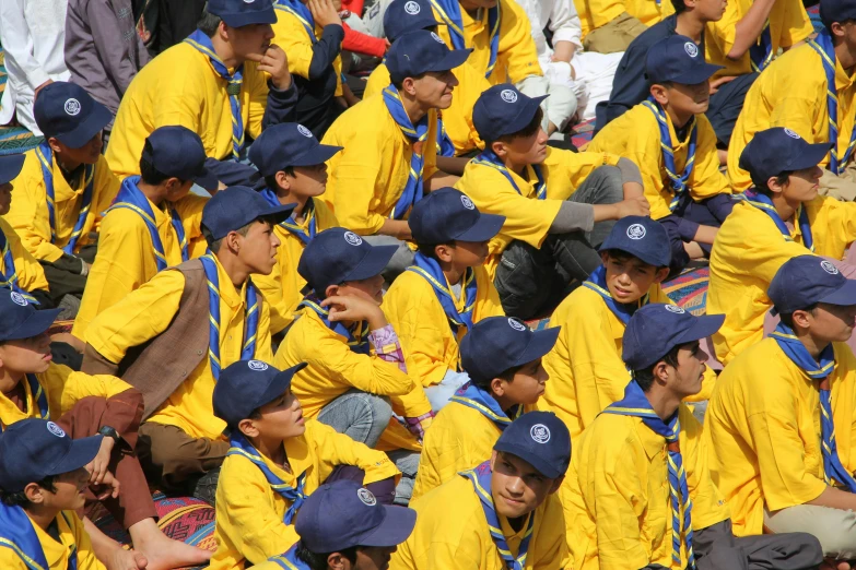 several yellow uniformed people and one wearing a blue hat