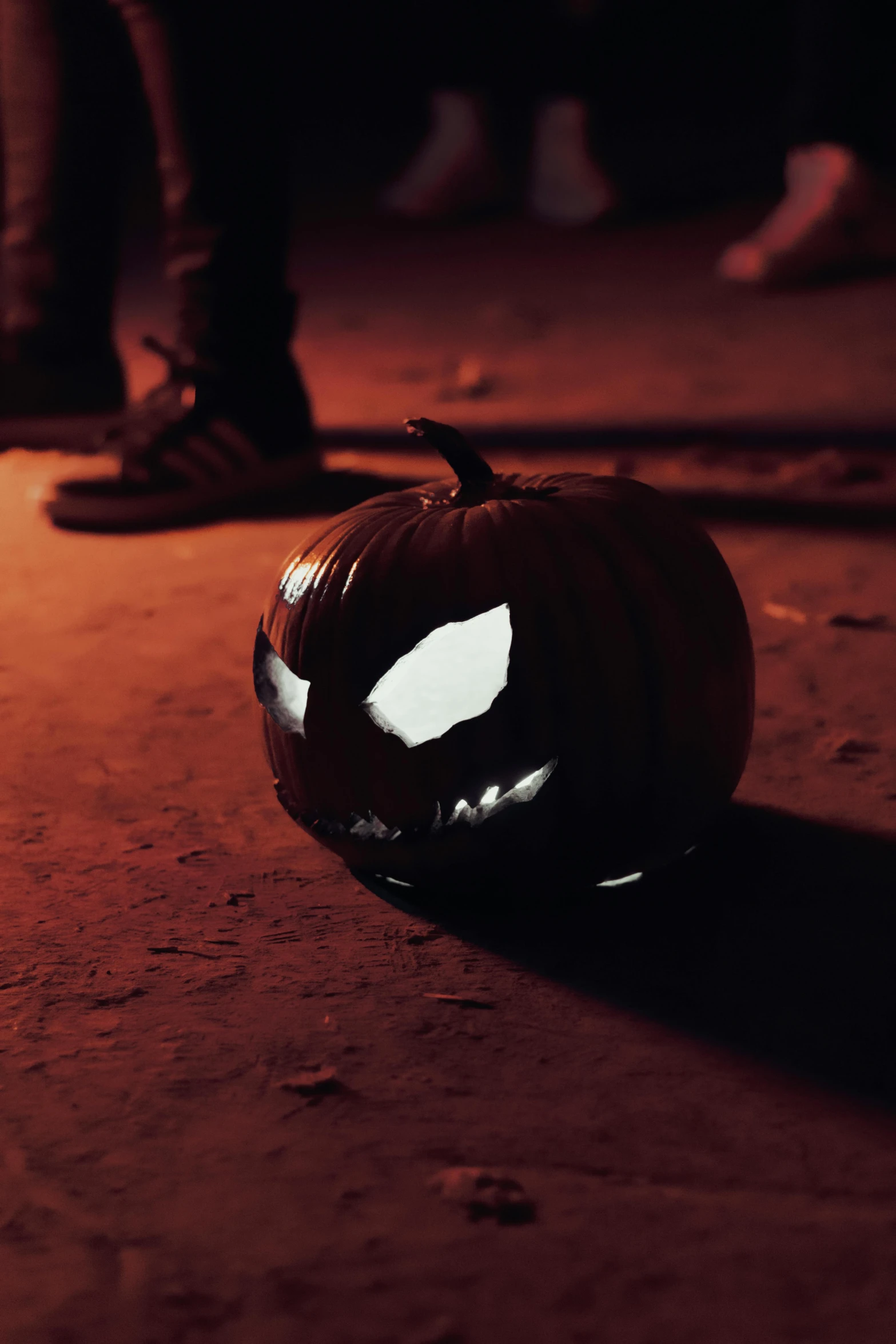 a black pumpkin that has its face in the dirt