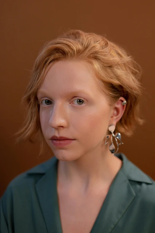 a woman with big hoops standing with her head turned backwards