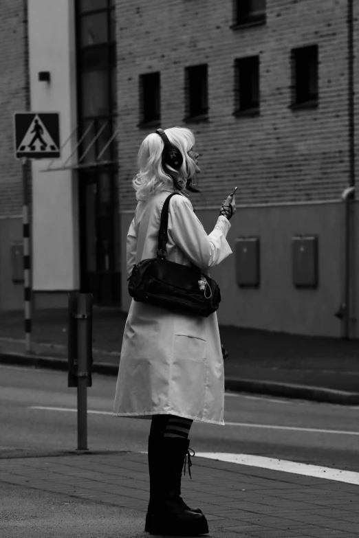 a woman standing on the side of a street