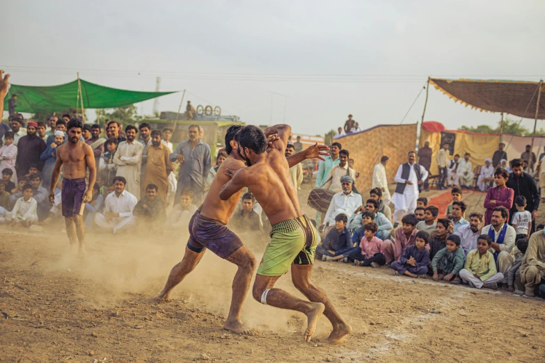 a man and a woman playing frisbee in front of crowd