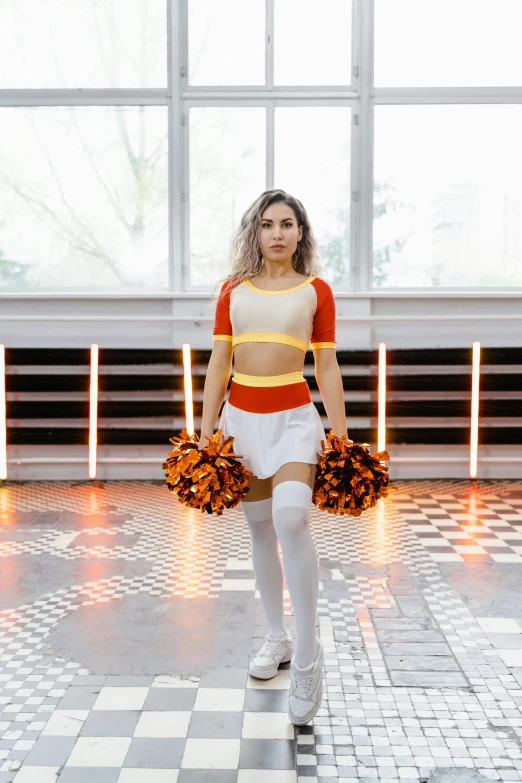 a girl is walking in the same dress as a cheerleader