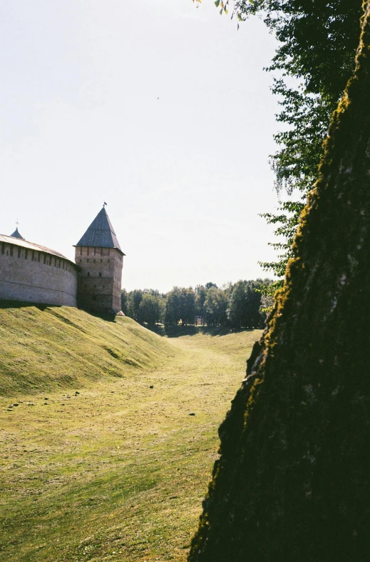 a barn perched on top of a green hill