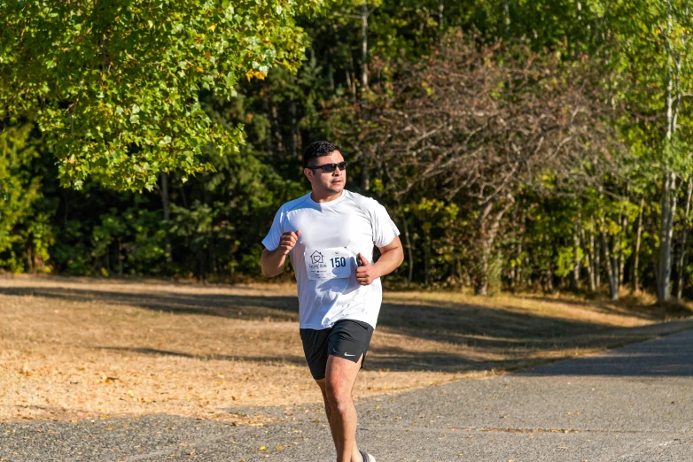 a man is running while wearing sunglasses