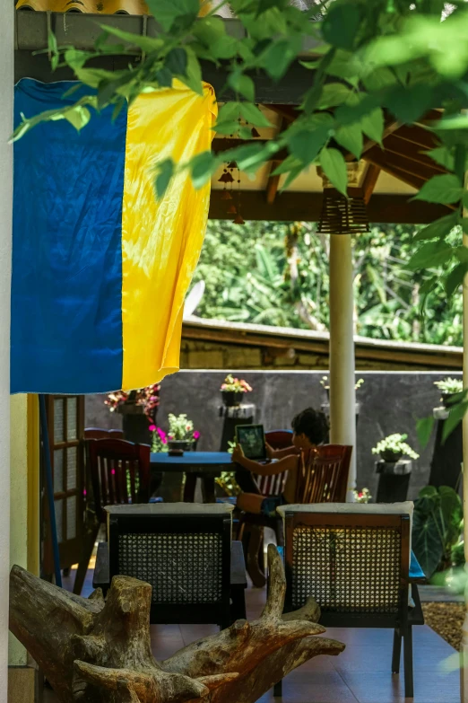 chairs and tables in front of an umbrella