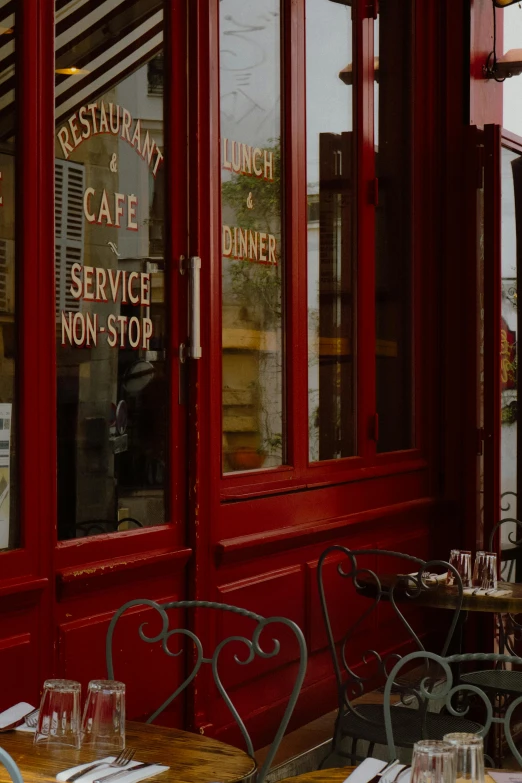 a table and chairs in front of a restaurant window