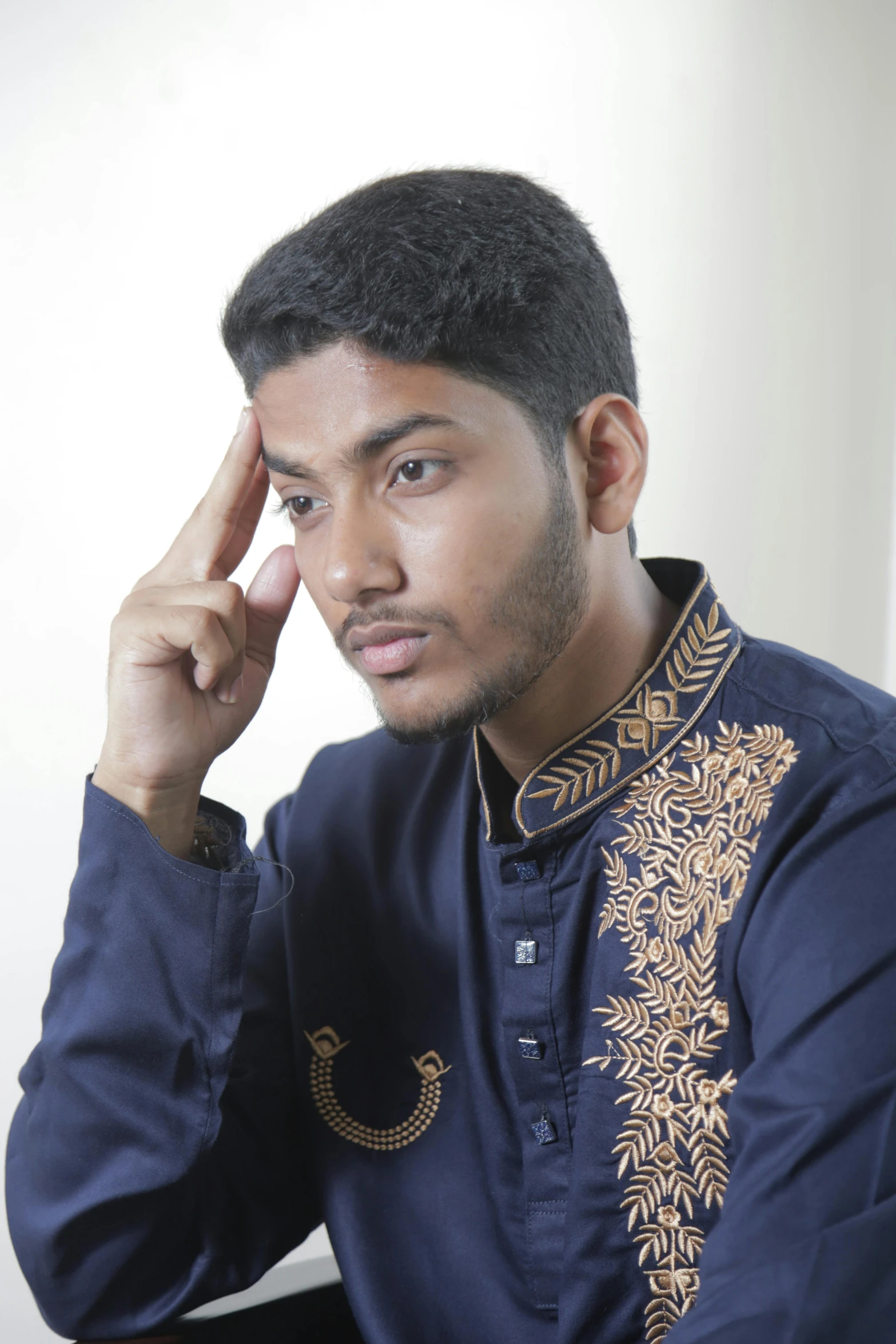 a man with a blue top and a gold jacket