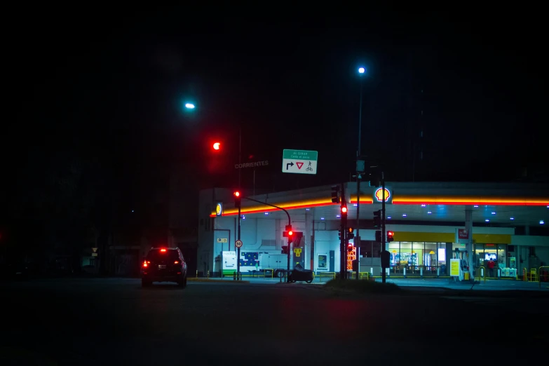 an oil station at night with street lights