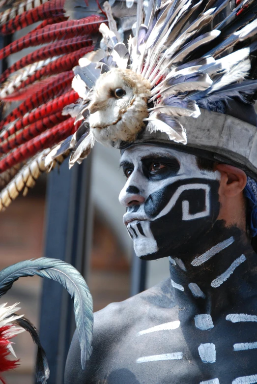 a person in a native indian outfit stands