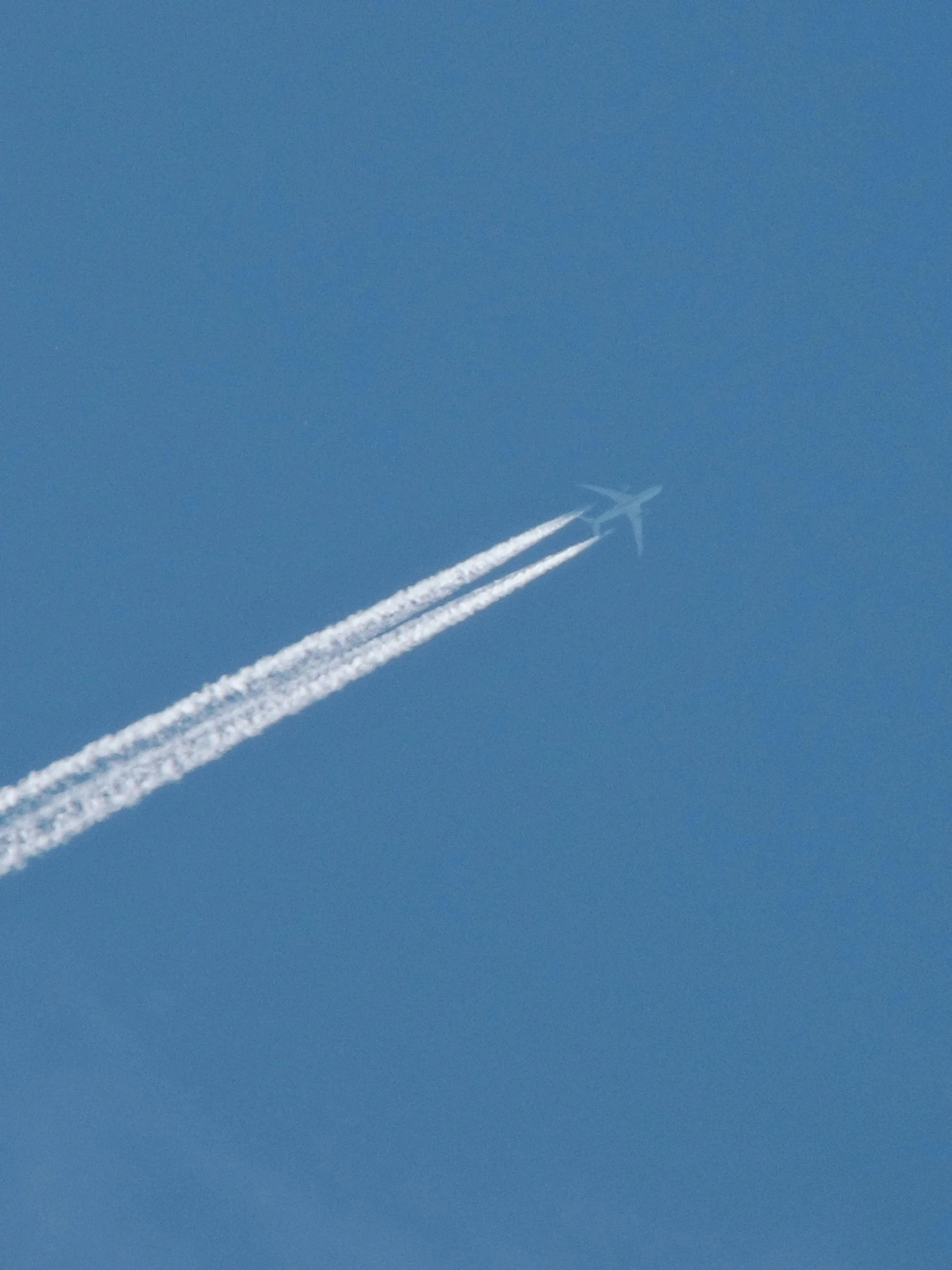 a jet with a white streak flying in the sky