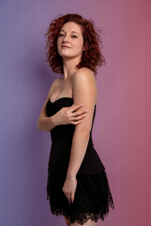 a woman posing in front of a purple background