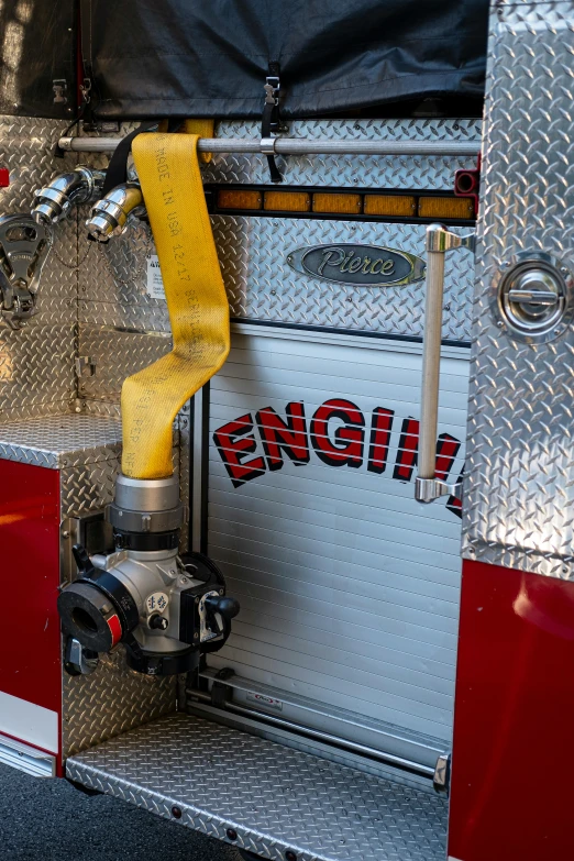 the back of a fire truck with hose and fire extinguisher