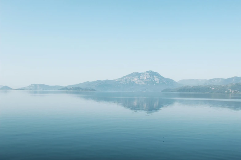 there is a mountain in the background next to the water