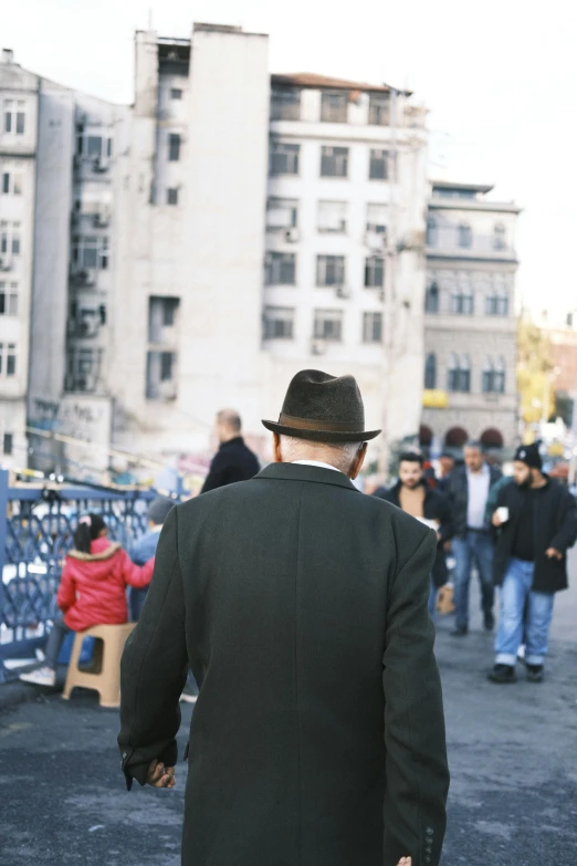 the man is walking down the street and talking to his friends