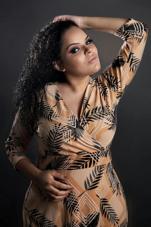 a woman wearing a patterned dress posing for a po