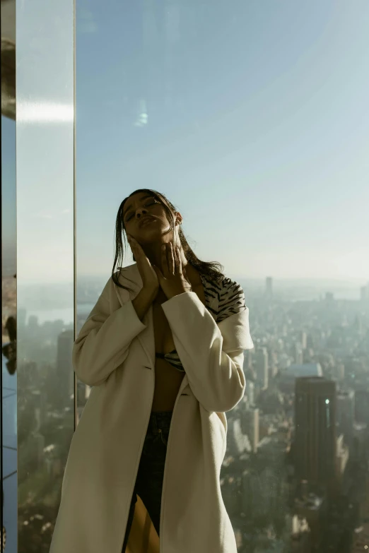 a woman wearing a coat is looking at her phone