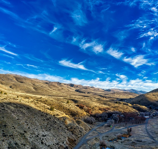 a rural village sits next to a mountain pass