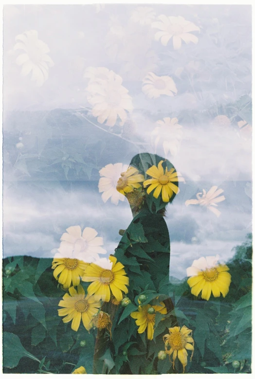 the man is sitting with two flowers in front of him