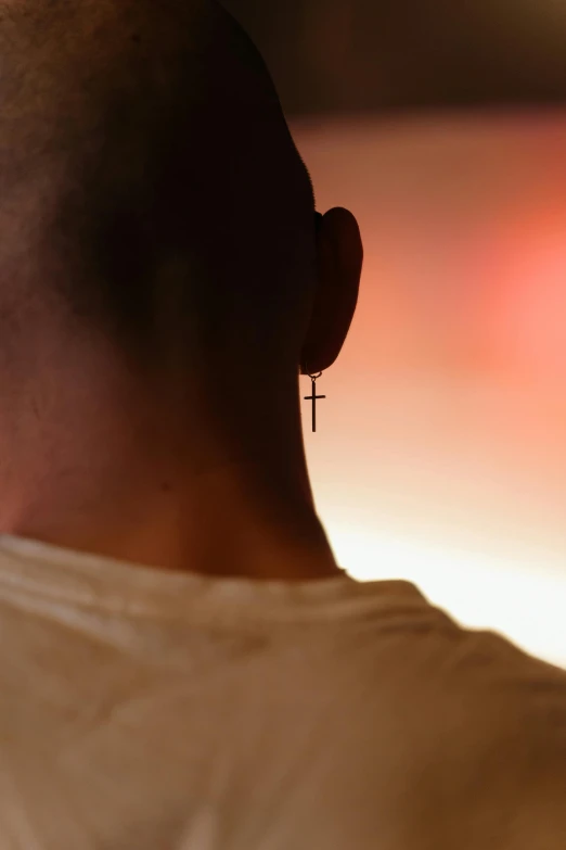 a man with a cross on his ear