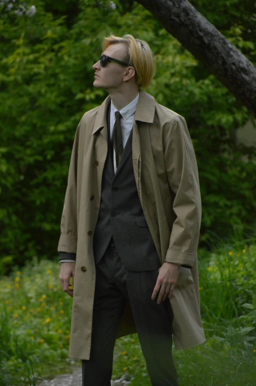 a man in sunglasses and a trench coat