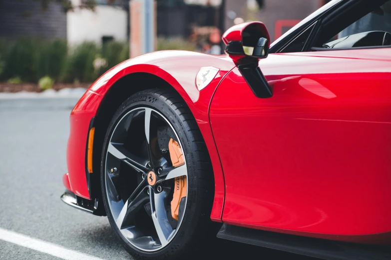 the red sports car is seen from the front end