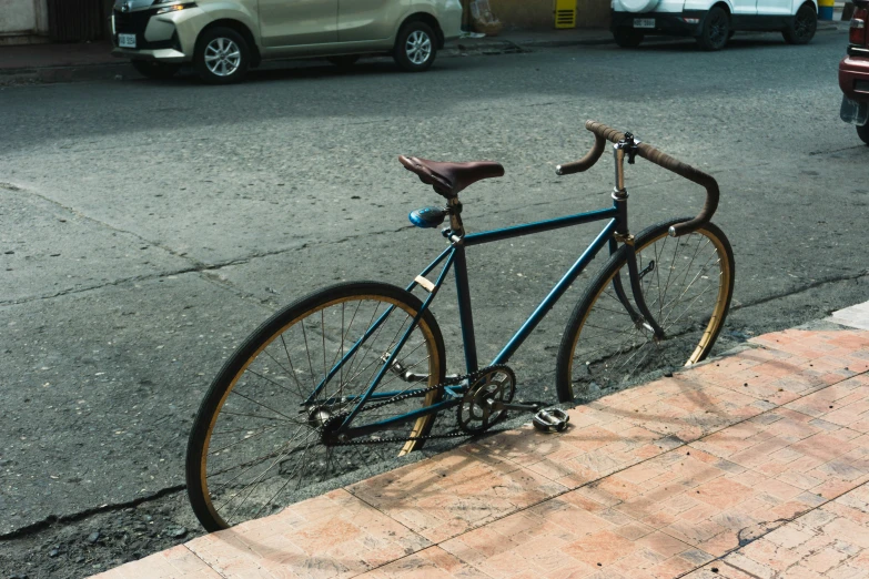 a bicycle sits on the curb in front of a building