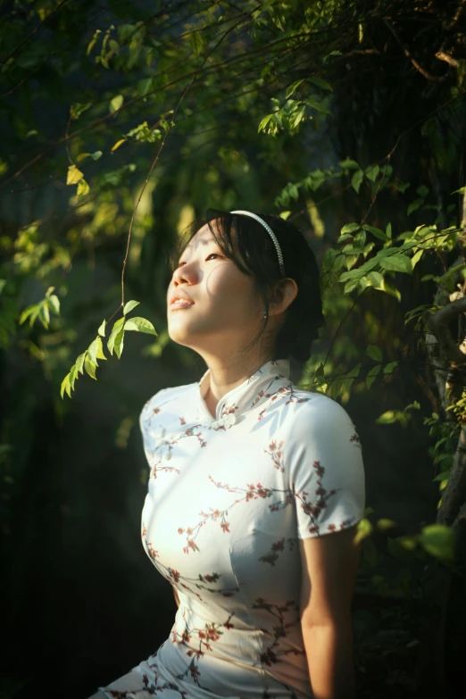 young asian woman enjoying the sunshine in an oriental garden