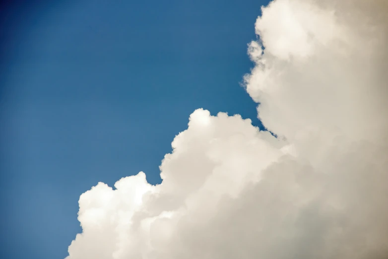 a jet flying high in the sky surrounded by clouds