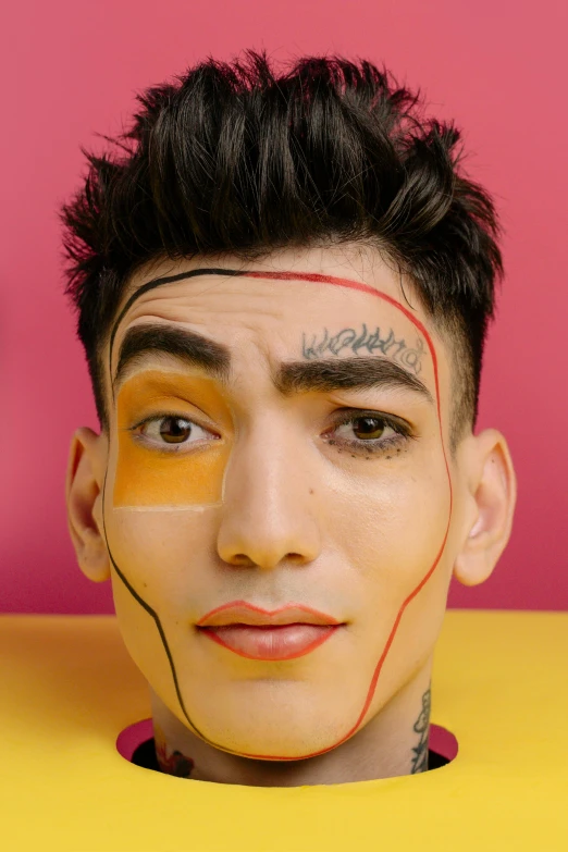 a man with face paint and a yellow shirt