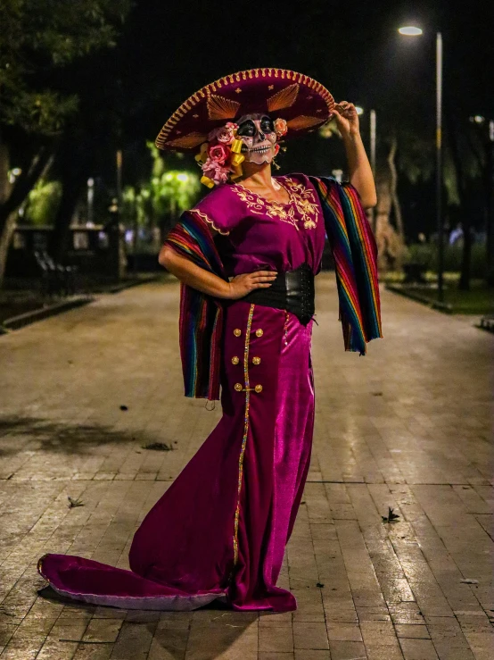 woman in costume, holding fan and hat on her head