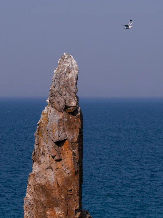 a rocky outcropping off the coast line of an island