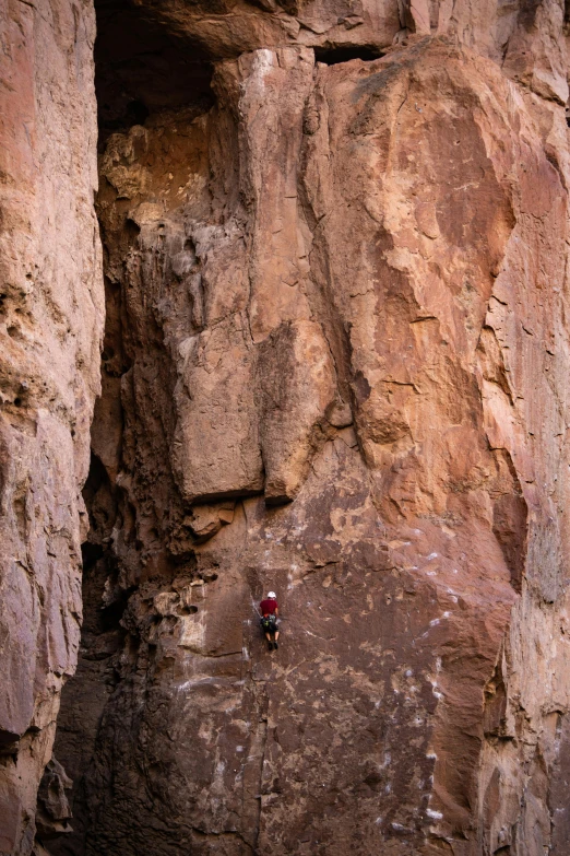 a man climbs into the small cave