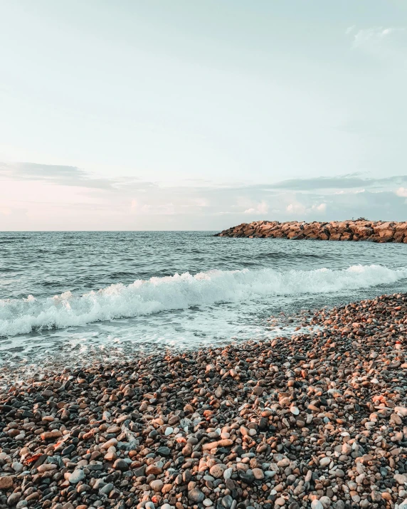 a rocky shore and small waves splash into the water