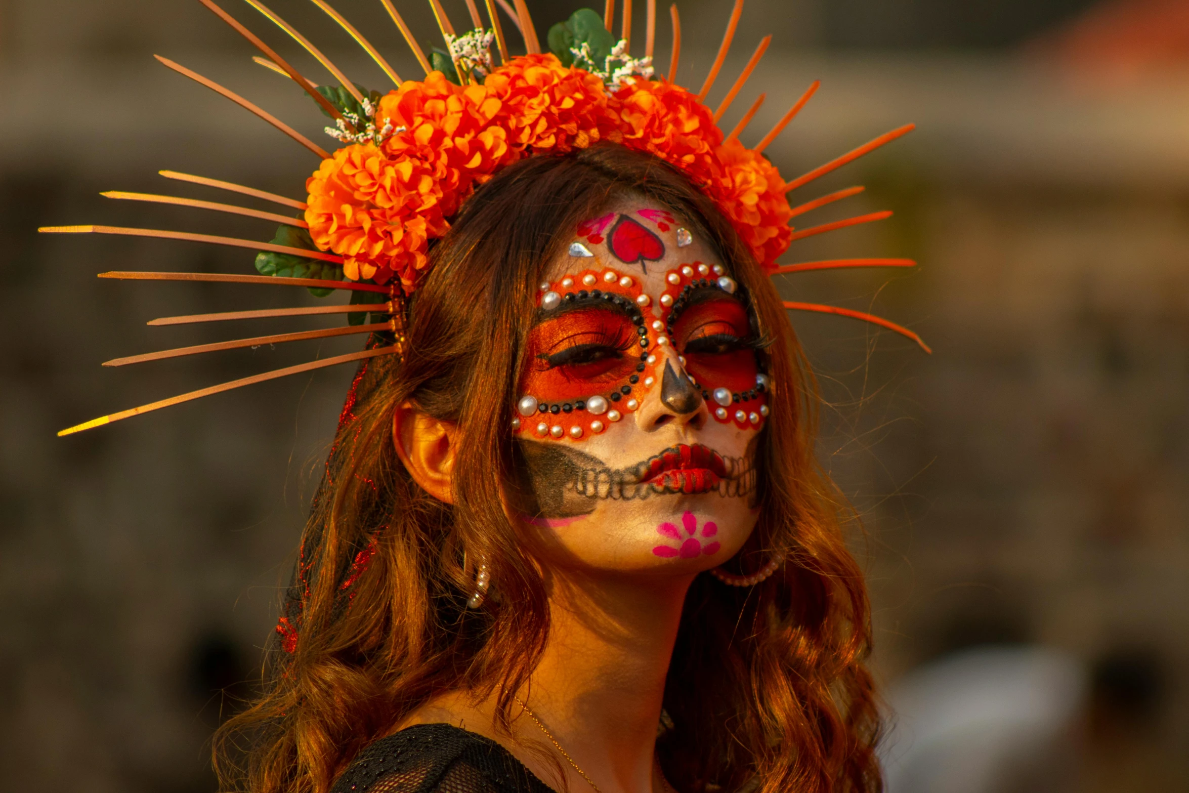 a woman with day of the dead makeup and flowers