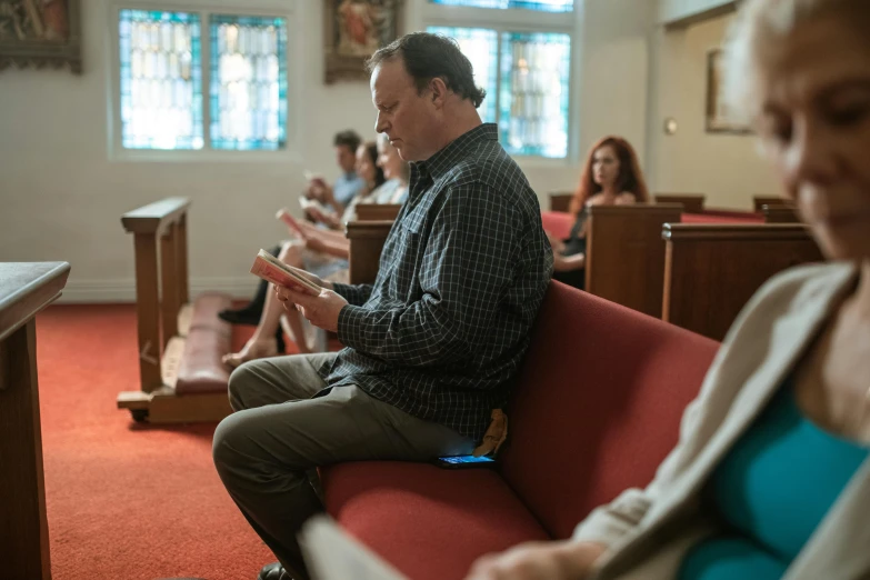 some people sitting and waiting in a church