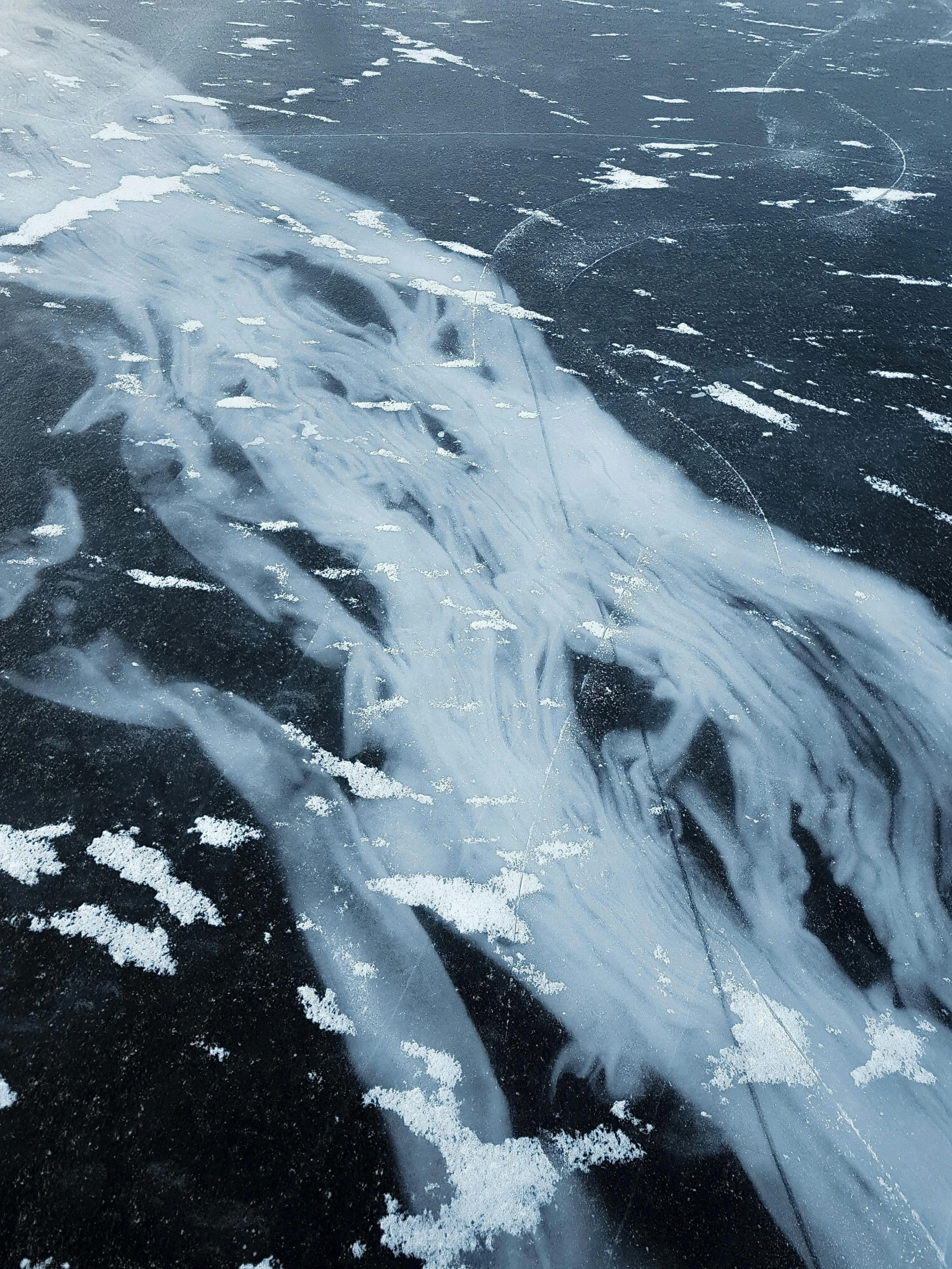 view of clouds flying over some snow covered land